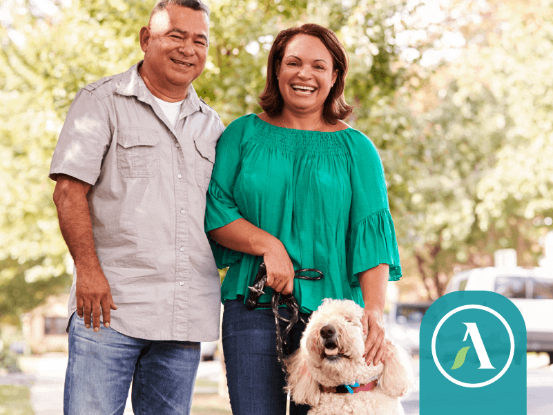 retired couple walking dog